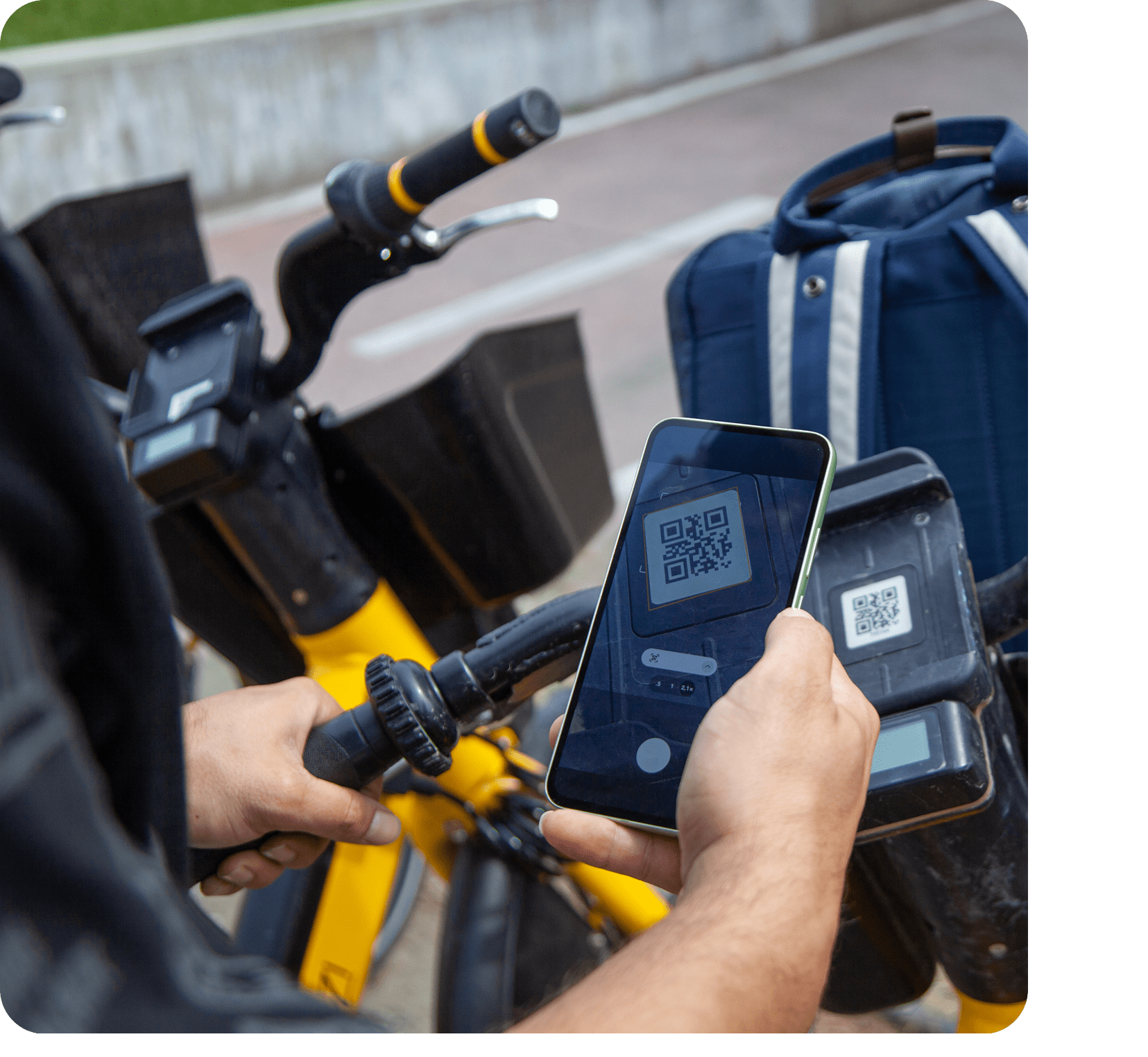 Man's hand scanning QR code to rent an electric bike