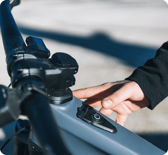 Cyclist checking phone near modern building